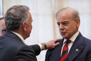 Pakistan's Prime Minister Shehbaz Sharif (R)